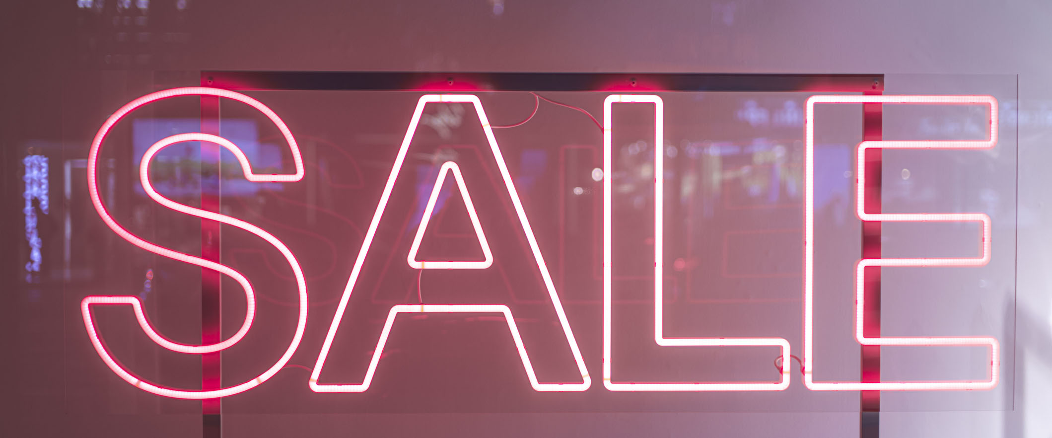 Neon pink sign that says "sale" in capital letters.