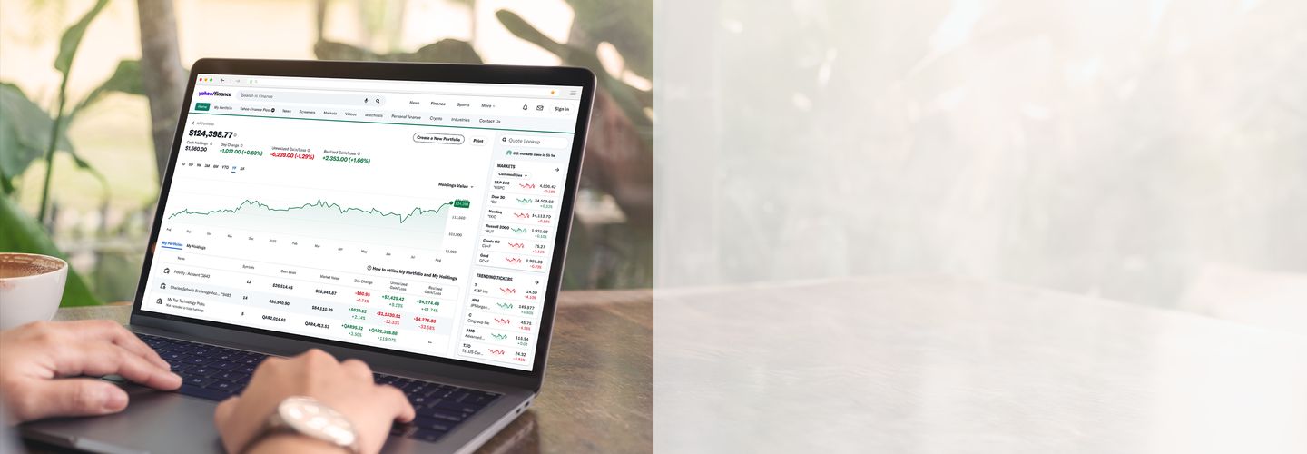 A person’s hands on the mouse of a laptop computer viewing the connected portfolio feature on Yahoo Finance.