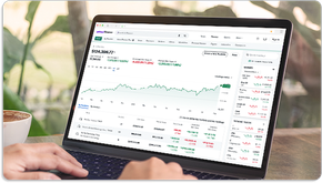 A person’s hands on the mouse of a laptop computer viewing the connected portfolio feature on Yahoo Finance