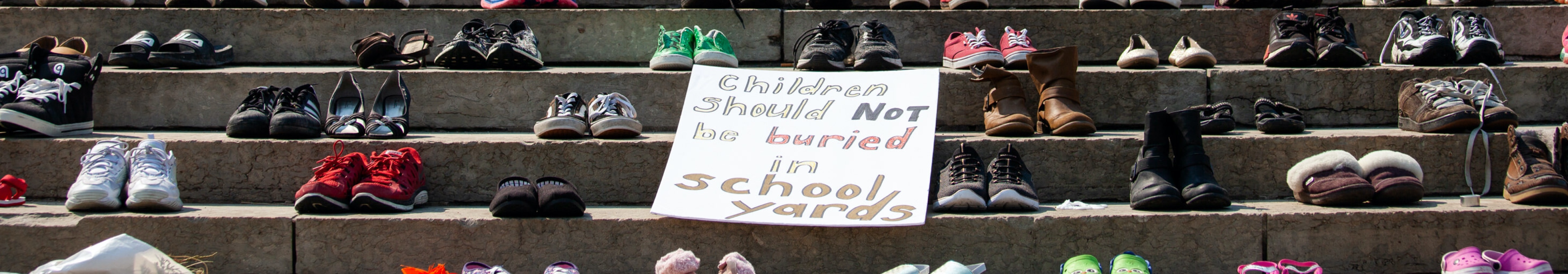  Shoes placed on the steps of the Manitoba Legislature to honour hundreds of children recently discovered in unmarked graves on the sites of several former residential schools across Canada near the now toppled statue of Queen Victoria on July 2, 2021 in Winnipeg, Manitoba, Canada. The statue was pulled down by indigenous protestors following a march to honour survivors and victims of Canadaâs residential school system. (Photo by Daniel Crump/Anadolu Agency via Getty Images)