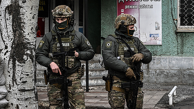 Ukrainian troops patrol in the town of Novoluhanske, eastern Ukraine, on February 19, 2022.