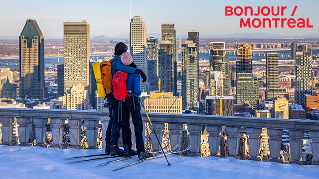 A couple embraces while looking out at the Montreal skyline from the Kondiaronk Belvedere in Mount Royal Park