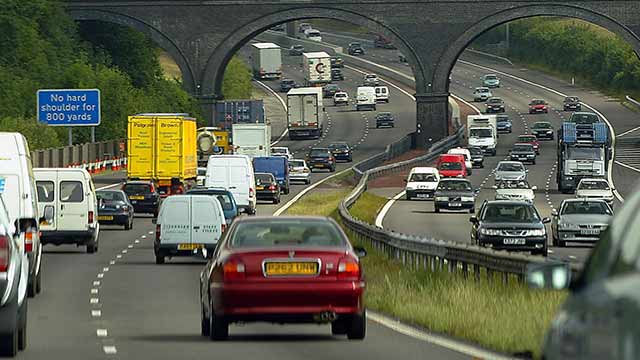 Motorists drive in heavy traffic on the M25 motorway July 9, 2003 in London, England. Britain's Transport Secretary, Alistair Darling, has announced a massive road-building programme, that includes widening large parts of the M1 and M25 motorways. Under consideration are plans to introduce road charges to help reduce congestion