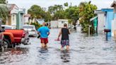 Toppled trees, pools of water fill South Florida streets. See rain-drenched scenes