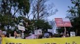 A group of people rally outside Tokyo's National Diet Building against a government plan to allow joint custody after divorce