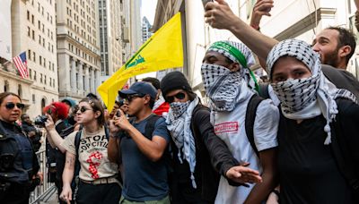 Pro-Palestine protester waves terrorist flag in front of New York Stock Exchange