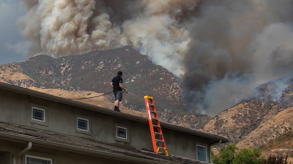 Residents flee as California and Nevada wildfires get dangerously close and forecasters warn of record heat