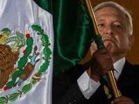 Mexican President Andres Manuel Lopez Obrador waves the national flag during Independence Day celebrations