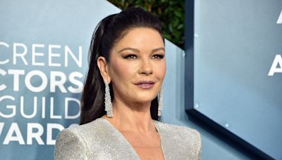 Catherine Zeta-Jones, 51, is still hula-hooping — this time, in a striped bikini