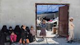 Scores of Syrians return home after years at camp housing people linked to the Islamic State group