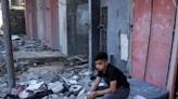 A boy sits amid rubble at the site of a building that was hit by Israeli bombardment in Rafah