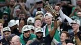 Jaylen Brown of the Boston Celtics holds up the Bill Russell NBA Finals Most Valuable Player award after the Celtics' title-clinching victory over the Dallas Mavericks