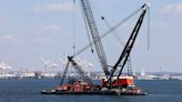 Massive crane put in place to clear Baltimore bridge debris as crews assess damage