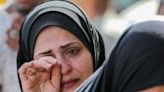 A Palestinian woman cries after identifying victims at the Al-Aqsa Martyrs Hospital in Deir al-Balah