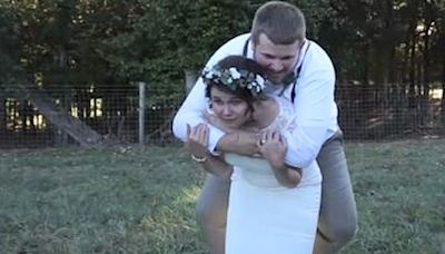 Watch the moment bride gives hubby piggyback but it goes horribly wrong