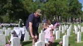 Volunteers place flags at Arsenal Cemetery ahead of Memorial Day