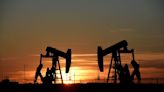 Oil prices settle lower on stronger supply outlook