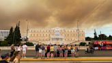 A wildfire near Greece's capital darkens the skies over Athens and advances fast