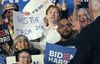 A supporter of US President Joe Biden holds a sign that read "Pass the torch Joe" during a campaign event in Madison, Wisconsin