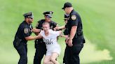 Protesters on course delay Travelers Championship. Scottie Scheffler waits on 18th hole