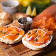 For seafood lovers, this board features an array of smoked or cured fish, such as smoked salmon, gravlax, or trout. Complement the seafood with cream cheese or herbed cheese spreads, capers, red onion, lemon wedges, and thinly sliced baguette.