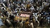 Death toll in Pakistan bombing rises to 54 as families hold funerals