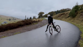 Cyclist Expertly Drifts Wet Corner