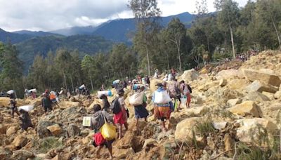 Race to rescue villagers trapped after deadly landslide