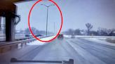 Watch moment pole crashes onto motorway inches away from police officer