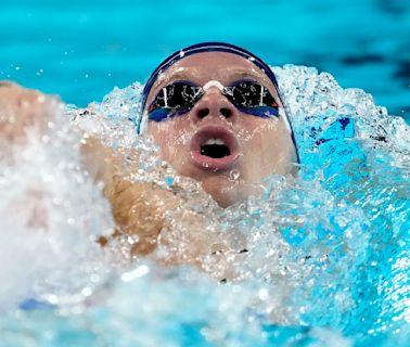 Paris Olympics: Léon Marchand lives up to the hype, and delights his native France — including President Macron