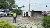 Dump truck flipped on its side in crash, causes temporary road closure for cleanup