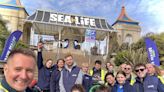 Aquarium staff go litter picking on beach as part of Earth Day