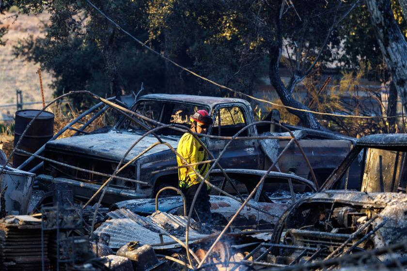 SoCal fires burn 100,000 acres, destroy dozens of homes and injure 13