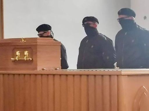 PSNI investigating image of masked men at Belfast crematorium