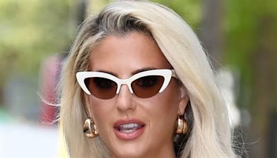 Selling Sunset's Emma Hernan puts on a sultry display in a tight unbuttoned dress and fox-eye sunglasses as she takes to the streets of London