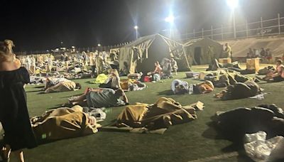 Holidaymakers from Wales sleep on football pitch as wildfires rip through Kos