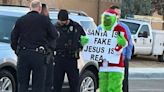 Texas Man Dresses as the Grinch, Stands Outside Elementary School with 'Santa Is Fake, Jesus Is Real' Sign