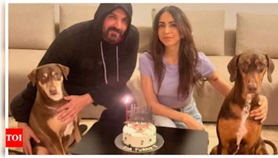 John Abraham and wife Priya Runchal pose for the cutest family picture as they celebrate their pooch's birthday | - Times of India