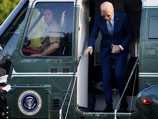 Pictured: Joe Biden ‘uses team of walkers to hide shuffling gait’ to Marine One