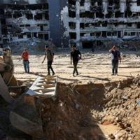 A bulldozer assists in the search for bodies at the Al-Shifa medical complex in Gaza City, where a medical official and Hamas authorities said an additional 49 corpses were uncovered