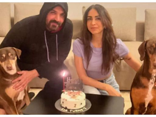 John Abraham and wife Priya Runchal pose for the cutest family picture as they celebrate their pooch's birthday | - Times of India