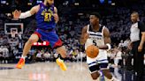 The Minnesota Timberwolves' Anthony Edwards drives against the Denver Nuggets' Jamal Murray during the third quarter in Game 3 of the Western Conference second-round playoff series at Target...