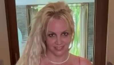 Britney suffers major wardrobe malfunction as her dress straps pop off on video