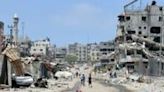 Palestinian children ride their bicycles along a street devastated by Israeli bombardment in Gaza City on May 3, 2024