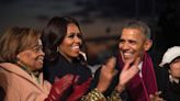 ...right, shares a laugh with first lady Michelle Obama and his mother-in-law, Marian Robinson... Tree lighting ceremony in President's Park outside the White House...