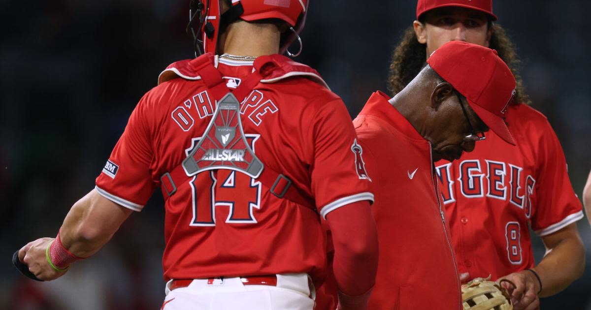 Los Angeles Angels manager Ron Washington on the mound as he makes a pitching change between infielder Cole Tucker and catcher Logan O'Hoppe, trailing 8-0 to the Kansas City...