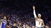 New York's Josh Hart celebrates his late three-pointer as Philadelphia's Kelly Oubre looks on in the Knicks' series-clinching victory over the 76ers in game six of their NBA Eastern...