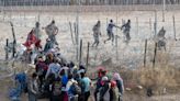 Watch: Surge of migrants pushes past National Guard troops at US border in Texas
