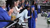 Student with cerebral palsy gets up from wheelchair to walk across stage at graduation