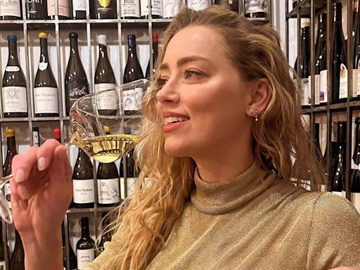 Amber Heard Smiles and Sips Champagne in Rare Photo to Celebrate Her 38th Birthday